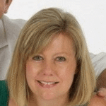 Portrait of Helen Mowat, Vice President of MI Care, smiling in a green top with a plain white background.
