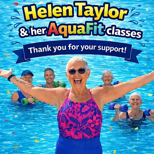 Older adults smiling in a bright blue swimming pool during an AquaFit class led by Helen Taylor, who stands front and center with arms outstretched in a pink and purple swimsuit.