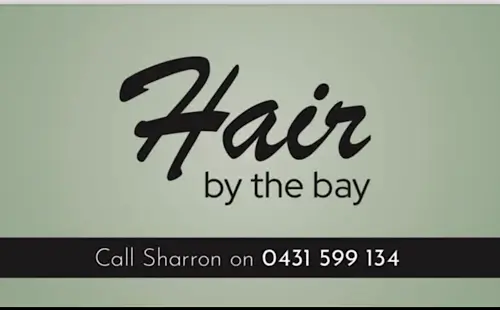 “Hair by the Bay,” featuring a simple design with the salon name and contact details for Sharron.